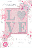 This anniversary card appears like a whispered promise carefully set down on a table in a cosy Bankside apartment, its design infused with soft intimacy and refined detail. The centrepiece is the word LOVE, with each letter standing slightly raised from the card in a velvety, glitter-kissed texture. The glitter is a muted pastel pink edged with silvery highlights, giving the impression of fine sugar crystals sprinkled over satin. The letter O is transformed into a shimmering heart, filled with denser silver glitter that adds depth and makes the centre glow gently against the soft background. Surrounding this focal word, delicate blooms in blush, mauve, and pale rose seem to bloom from the surface in a loose, almost watercolour style. Their petals are softly shaded, with fine outlines and tiny veins that bring to mind the care a florist takes when selecting the most perfect flowers for an anniversary bouquet. Slender vines, curling tendrils, and tiny butterflies weave between the blossoms, adding motion and a feeling of airy grace, like a light breeze drifting across nearby riverside gardens. The palette blends pastel pinks with silvery greys and hints of white, creating a serene, romantic mood that echoes the quiet charm of Bankside's tucked-away streets. Scripted text reading On Our Anniversary and I love you today and always is penned in an understated yet elegant calligraphy, offering heartfelt sentiment without overpowering the delicate artwork. The overall impression is of a keepsake as tender and thoughtfully arranged as a hand-tied anniversary bouquet, perfect for celebrating a shared journey in and around Bankside.